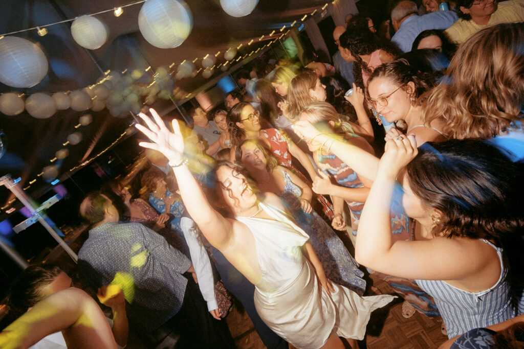 Hands in the air, dancing the night away in a color drenched dance party in Alexandria, MN. Many guests proclaimed this was "the best wedding dance by the best wedding DJ" they had ever heard. Photo by Jess McDole