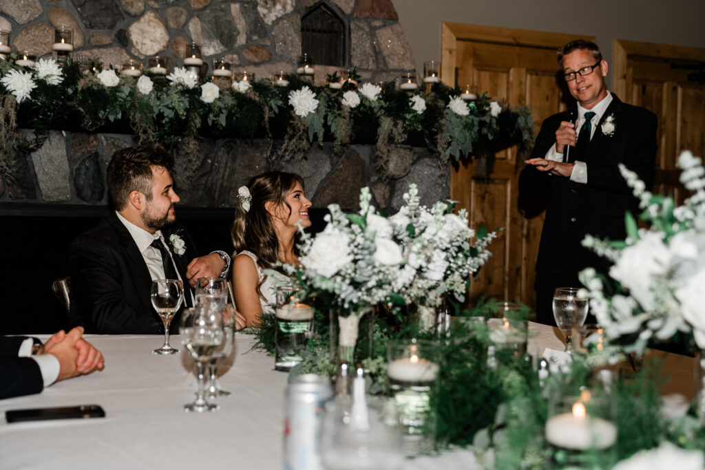 Father of the bride giving a perfectly timed speech cued by the master of ceremonies at a Minnesota wedding reception