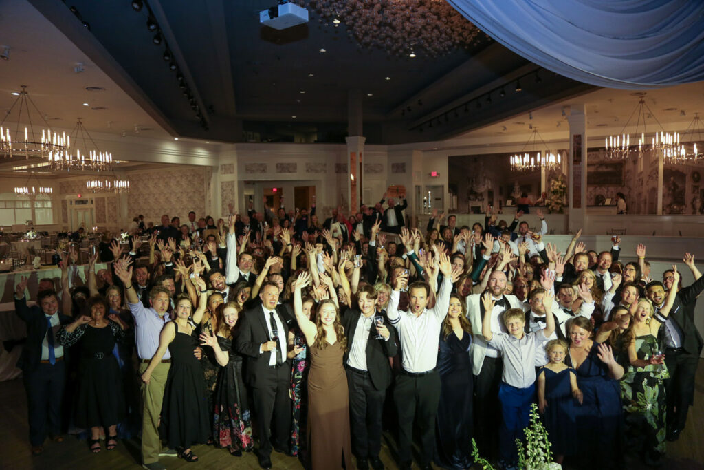 A large group celebrating a Minneapolis couple inside The Metropolitan Ballroom.