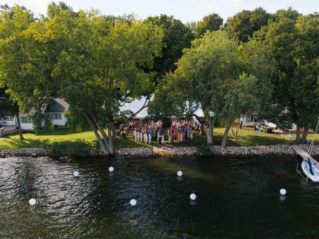 Aerial view of a lakeside wedding ceremony at a family cottage in Alexandria, MN